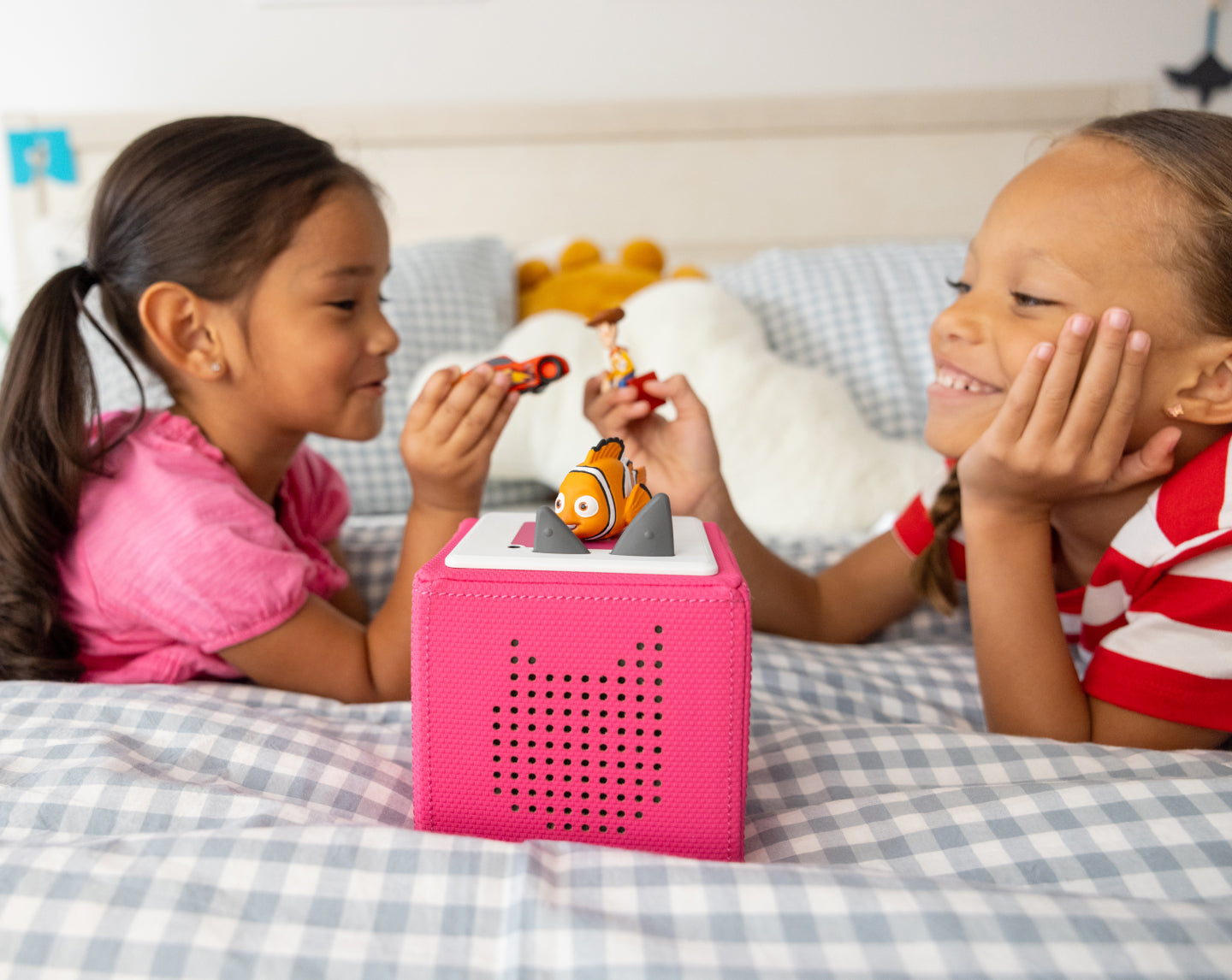 children playing inside with tonies and a pink toniebox