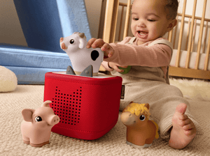 child playing with a toniebox 2 and a my first tonies farm set