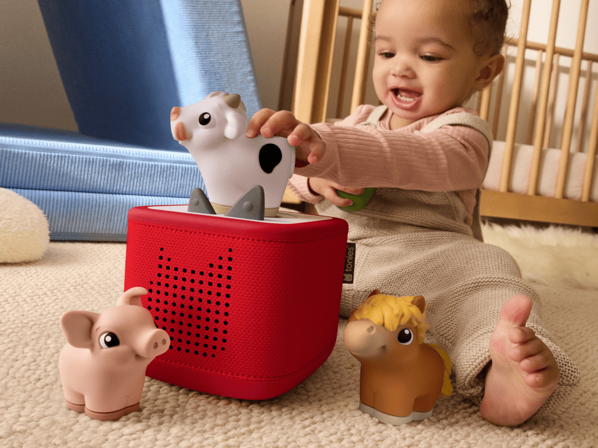 child playing with a toniebox 2 and a my first tonies farm set