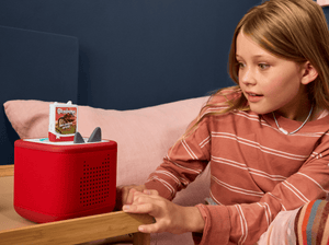 child in a room listening to Goosebumps Book Tonies on a red toniebox 2