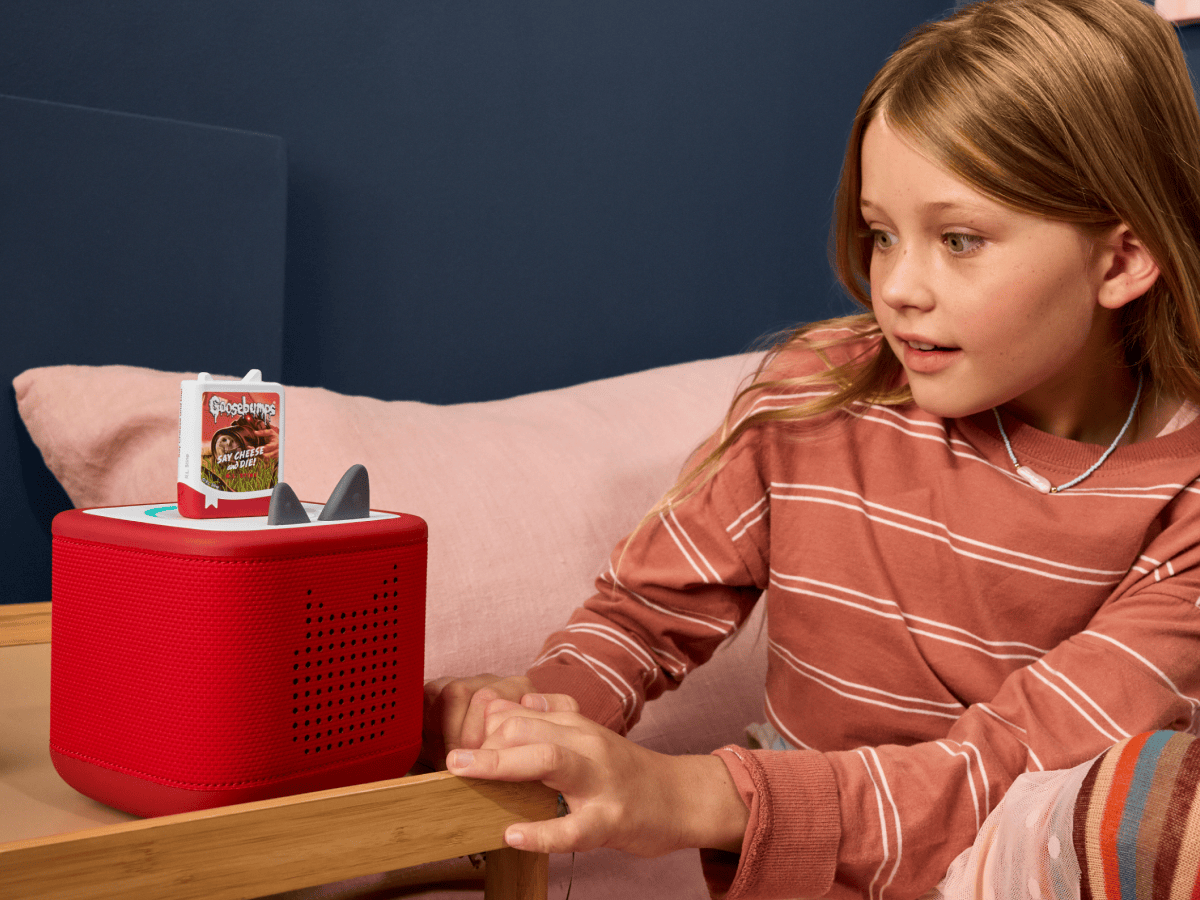 child in a room listening to Goosebumps Book Tonies on a red toniebox 2