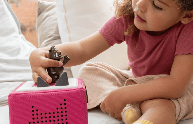 Girl listening to the Gruffalo Tonie on a pink Toniebox