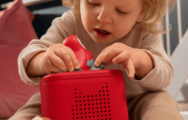 Child playing with My First Tonies and a red Toniebox 2