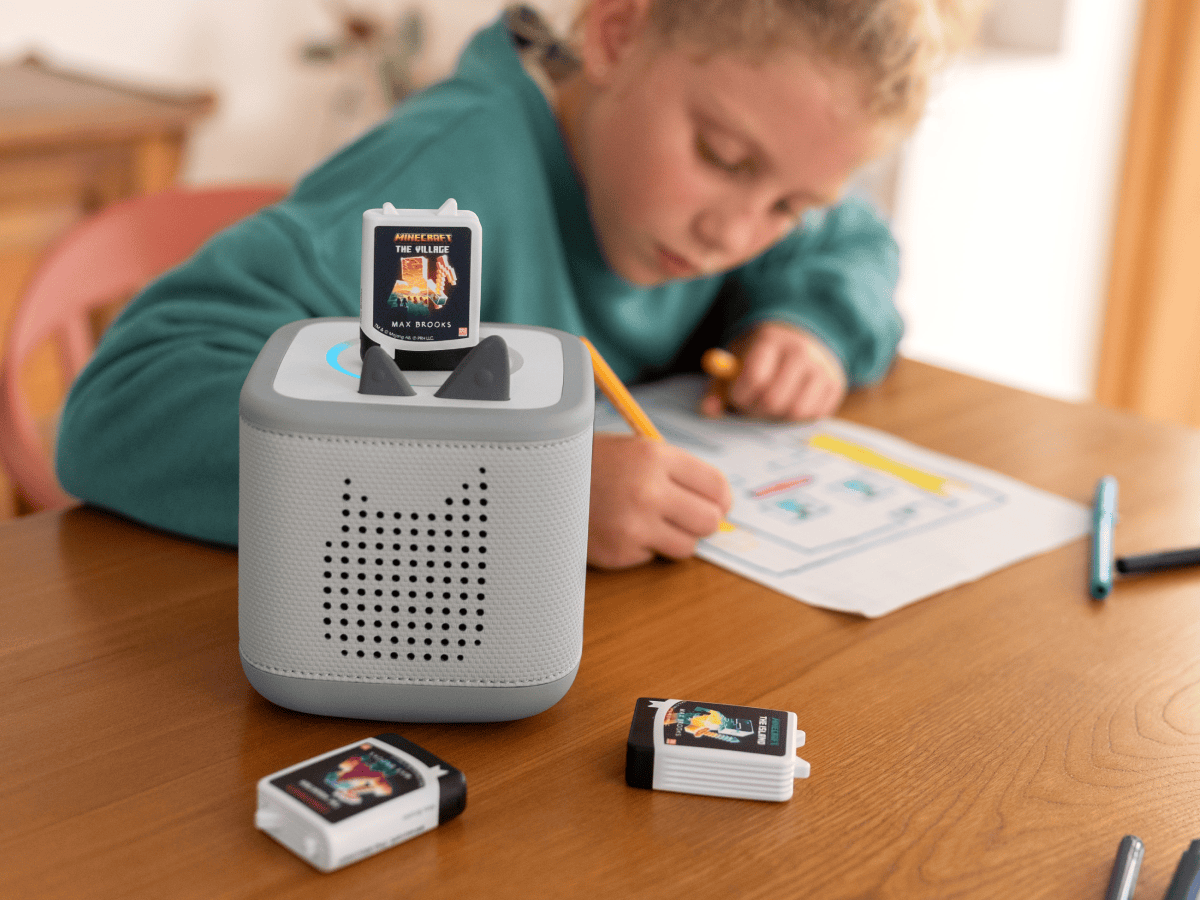 Lifestyle image of child listening to Minecraft Audiobook Tonie on Gray Toniebox 2