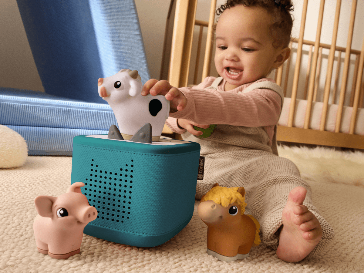 child playing with toniebox 2 and my first tonies horse, cow and pig