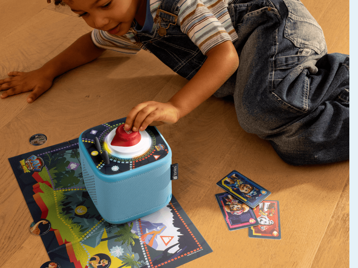 Child playing wth Tonieplay PAW Patrol Dino Movie Dino Island Rescue Mission and a toniebox 2