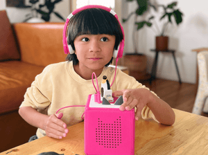 Child Playing With Penguin Tonie Audio Figurine And Toniebox 2