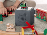 Child playing with All Engines Go: Percy Tonie audio figurine and Toniebox 2
