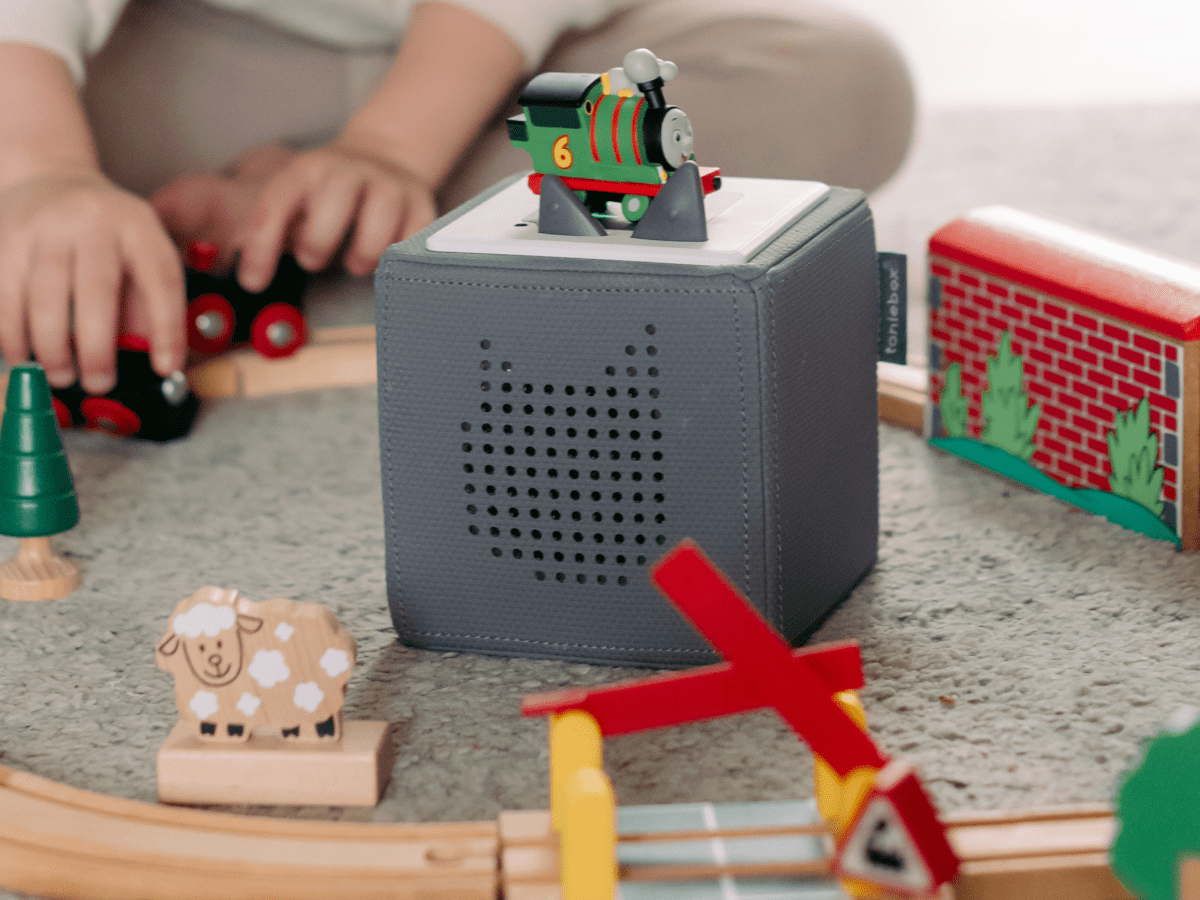 Child playing with All Engines Go: Percy Tonie audio figurine and Toniebox 2
