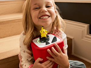 child holding the Pokémon Pikachu Tonie and a toniebox 2