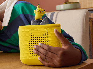 child holding the Pokémon Pikachu Tonie and a toniebox 2