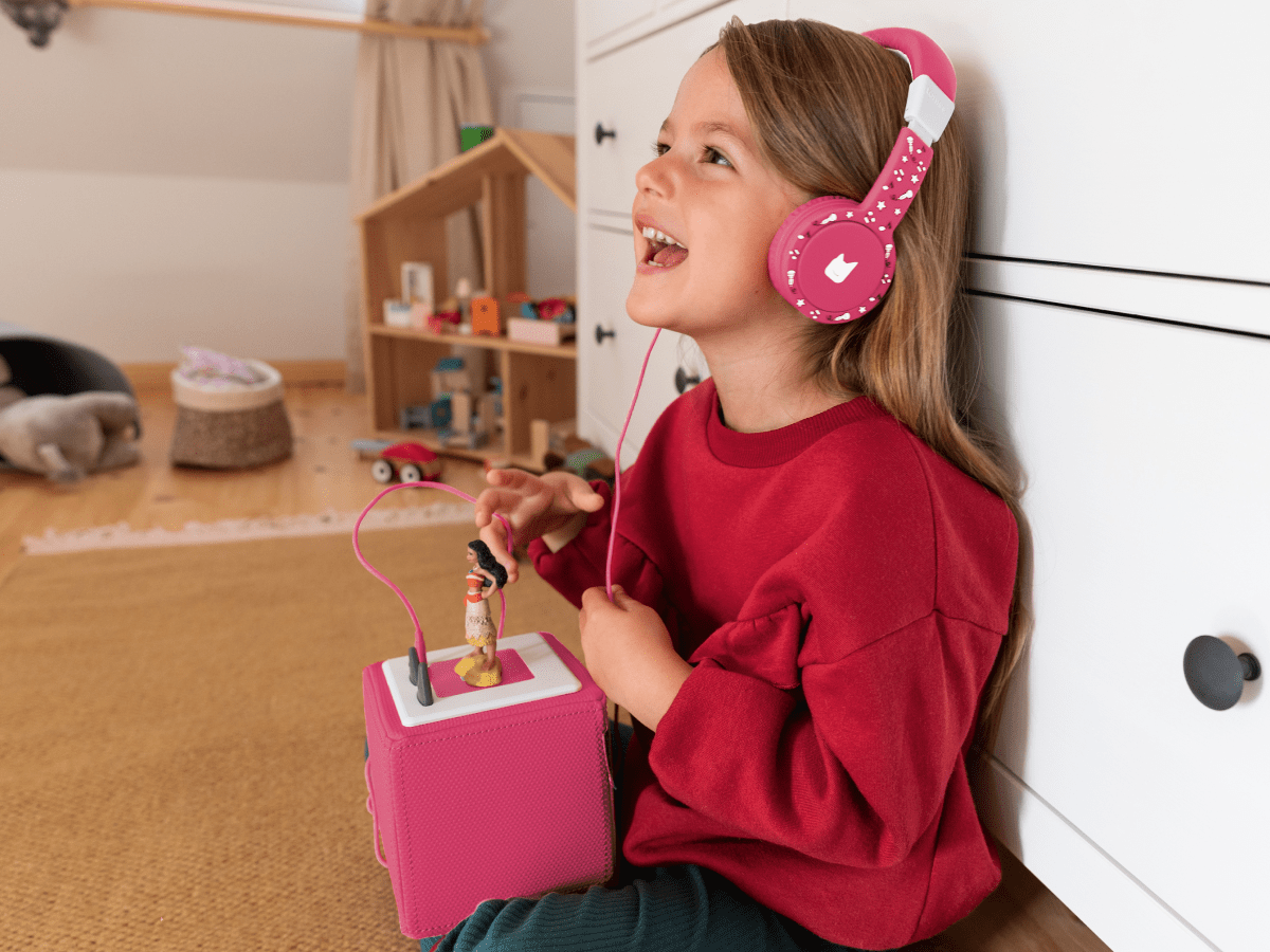 Child using with Pink Headphones for Kids