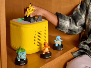 child playing with a lightning yellow toniebox 2 and four pokemon tonies