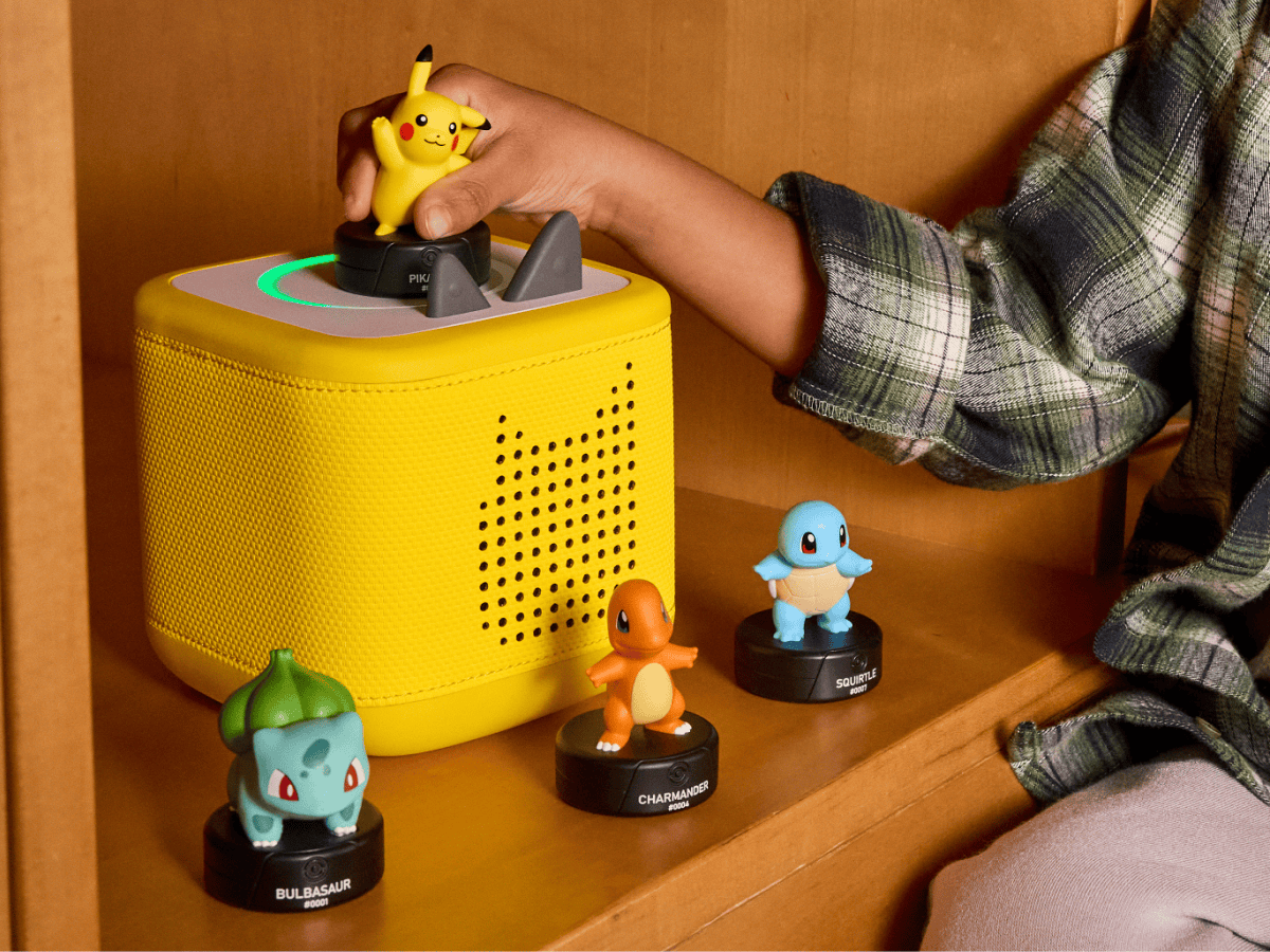 child playing with a lightning yellow toniebox 2 and four pokemon tonies