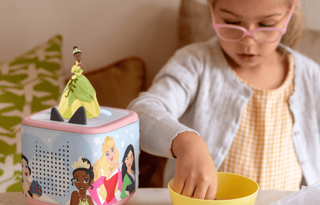Disney The Princess & The Frog Tonie on a pink Toniebox 2 with Princess Sleeve on it playing while a child enjoys craft time
