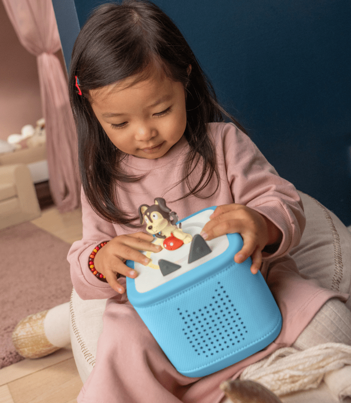 girl listening to playtime puppy Tonie on a blue Toniebox 2
