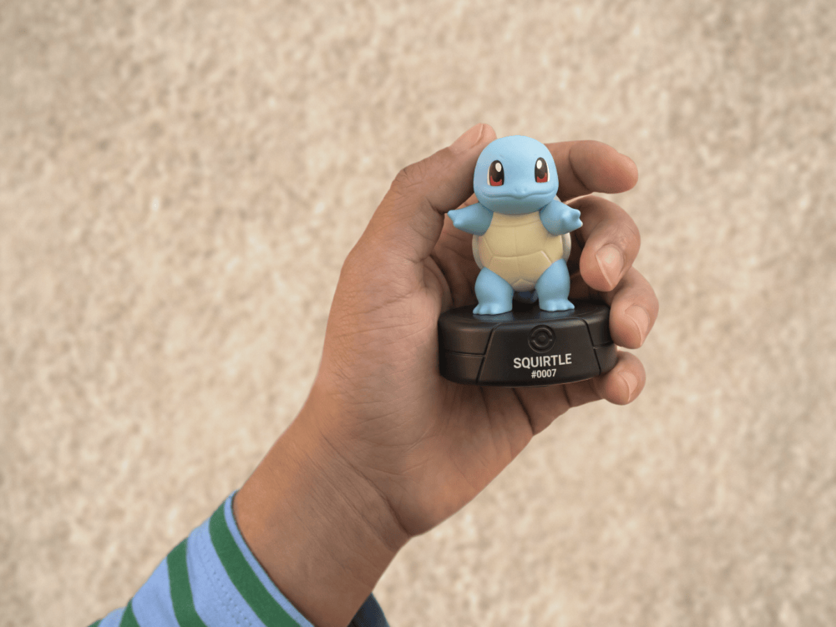 child holding the Pokémon Squirtle Tonie