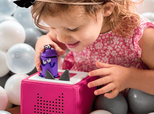 Child playing with Ask the StoryBots: Bo Tonie audio figurine and Toniebox 2