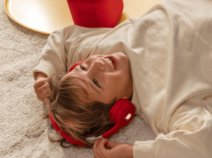 Child Listening To The Toniebox 2 And Tonie With Red Bluetooth Headphones For Kids
