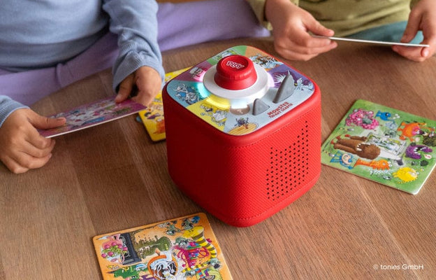 Children playing a Tonieplay game on a red Toniebox 2