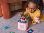 Kids playing with a red toniebox 2 and the quizzles animals tonieplay