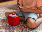 Kids playing with a red toniebox 2 and the quizzles technology tonieplay