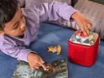 child playing with Disney Winnie The Pooh - Tigger's Mix-Up Fix-Up Tonieplay disc and a red toniebox 2 and Tonie