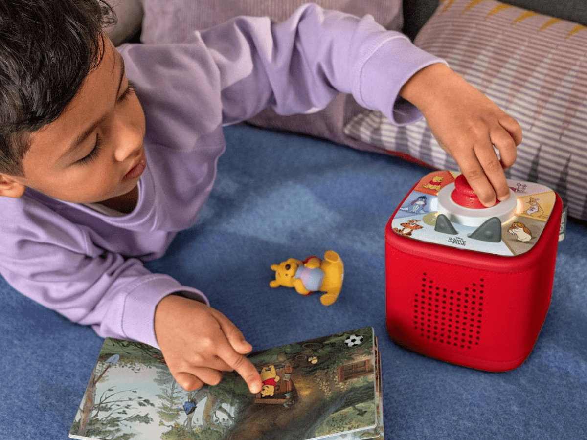 child playing with Disney Winnie The Pooh - Tigger's Mix-Up Fix-Up Tonieplay disc and a red toniebox 2 and Tonie