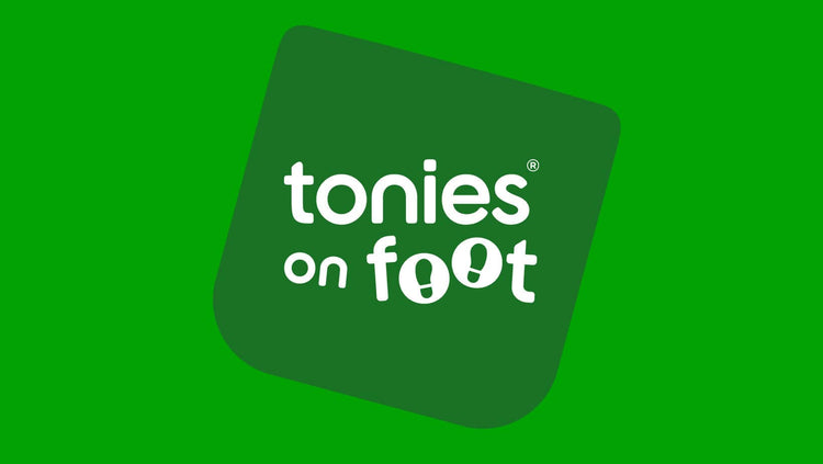 tonies on foot on green background
