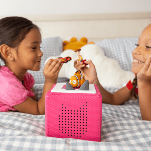 children playing with pixar tonies and a pink toniebox