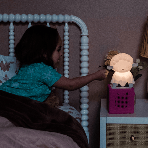 child getting ready for bed with a sleepy sheep night light tonie and toniebox