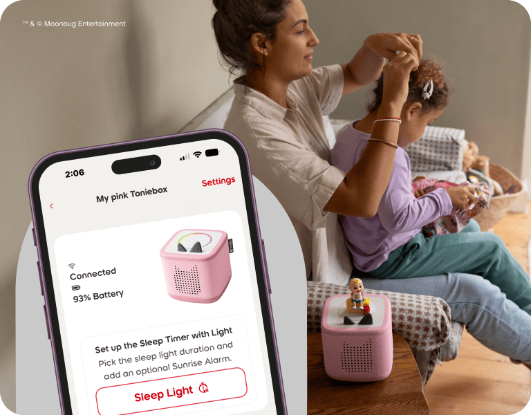 Woman and child with a pink Toniebox 2 and tonies app interface.