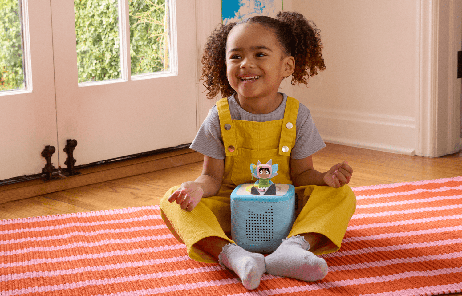 child playing with a blue toniebox 2 and fairy creative tonie