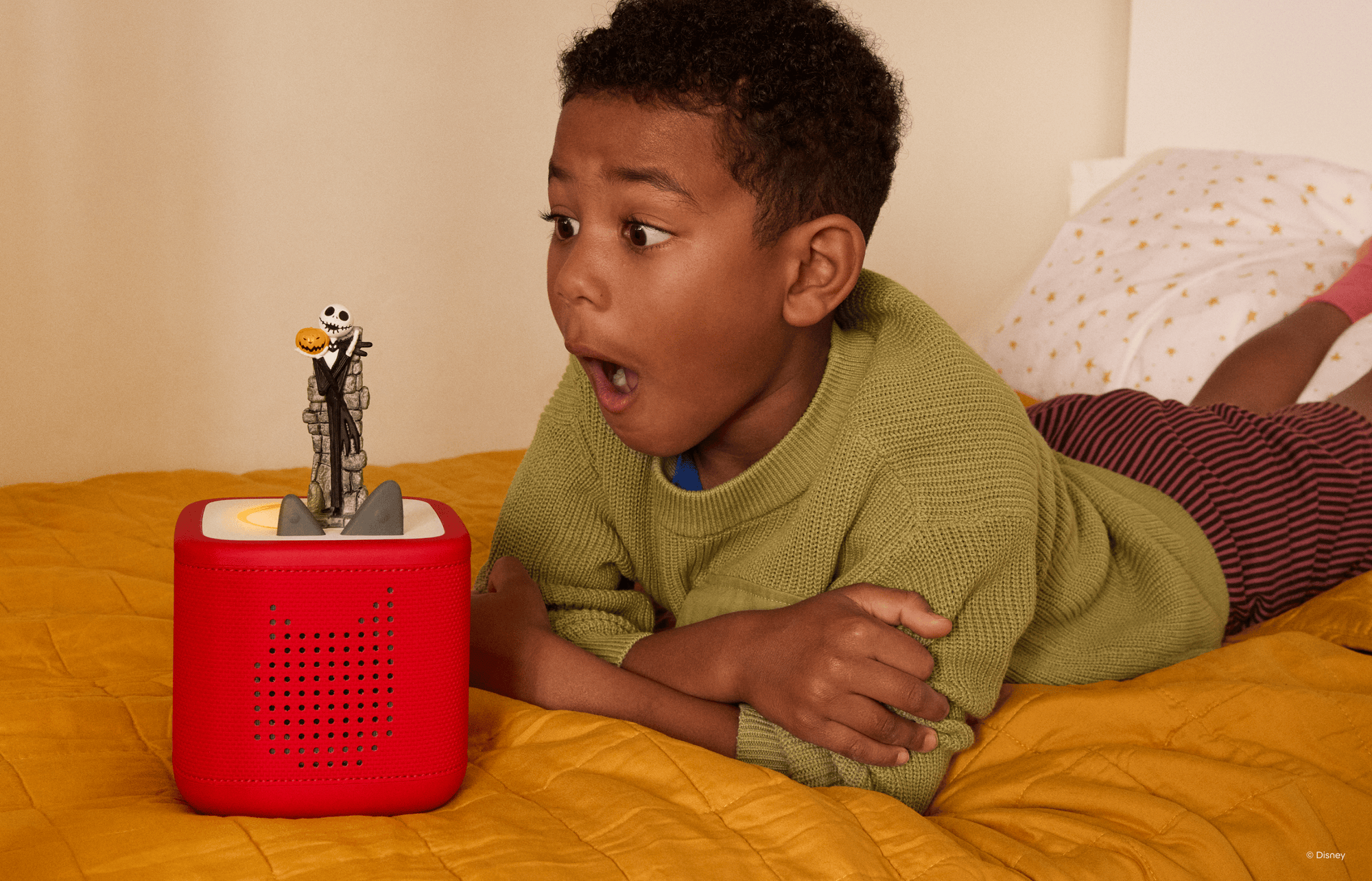 child listening to The Nightmare Before Christmas Tonie on a red Toniebox 2