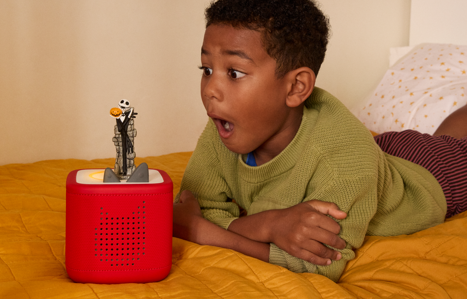child listening to The Nightmare Before Christmas Tonie on a red Toniebox 2