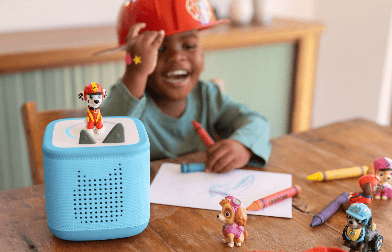 Girl holding a teal Toniebox 2 while the playtime puppy tonie is playing