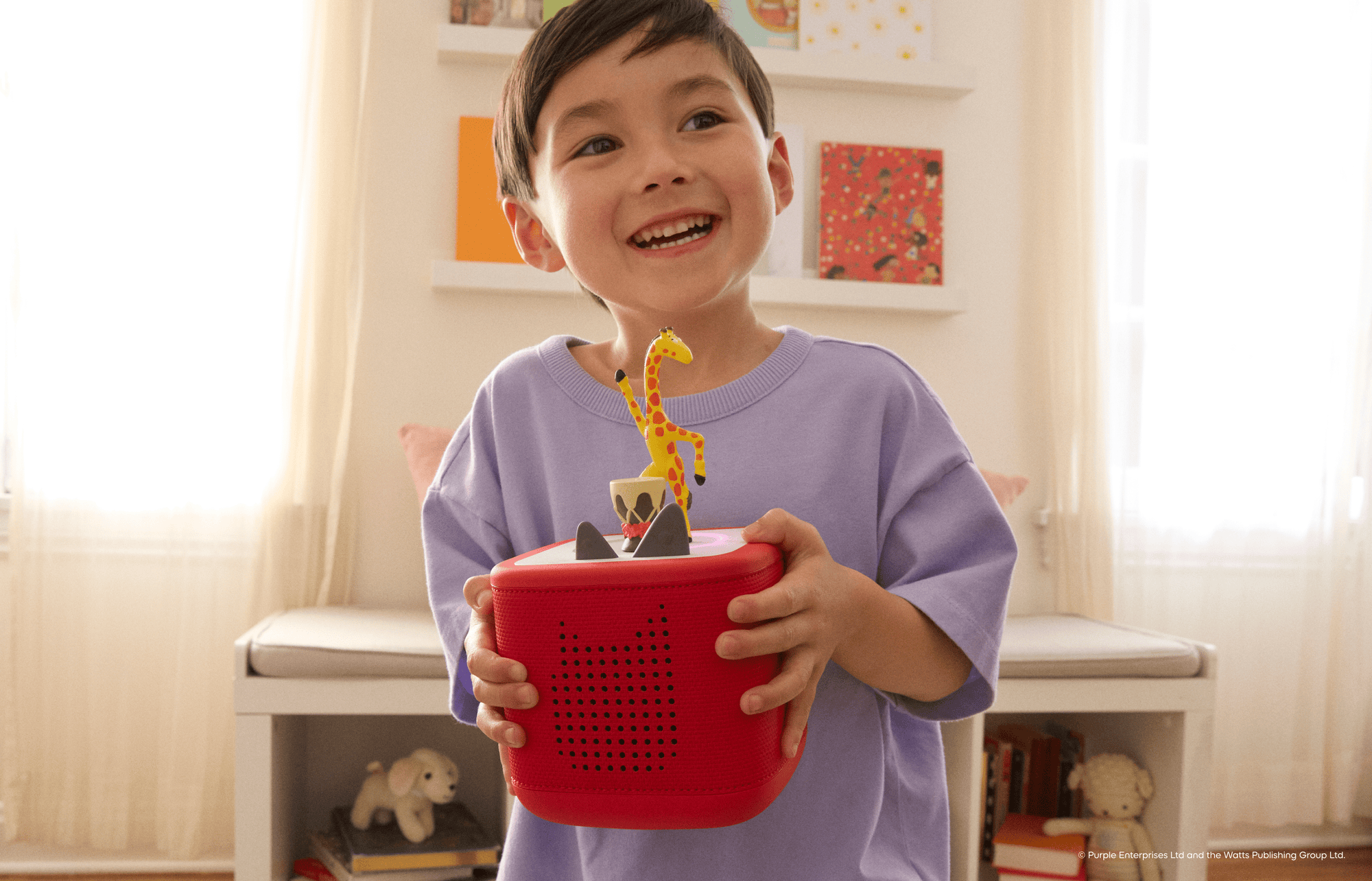 child listening to Giraffes Can't Dance Tonie on a red Toniebox 2