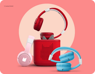 pink, red, and blue tonies bluetooth headphones with a red Toniebox 2.