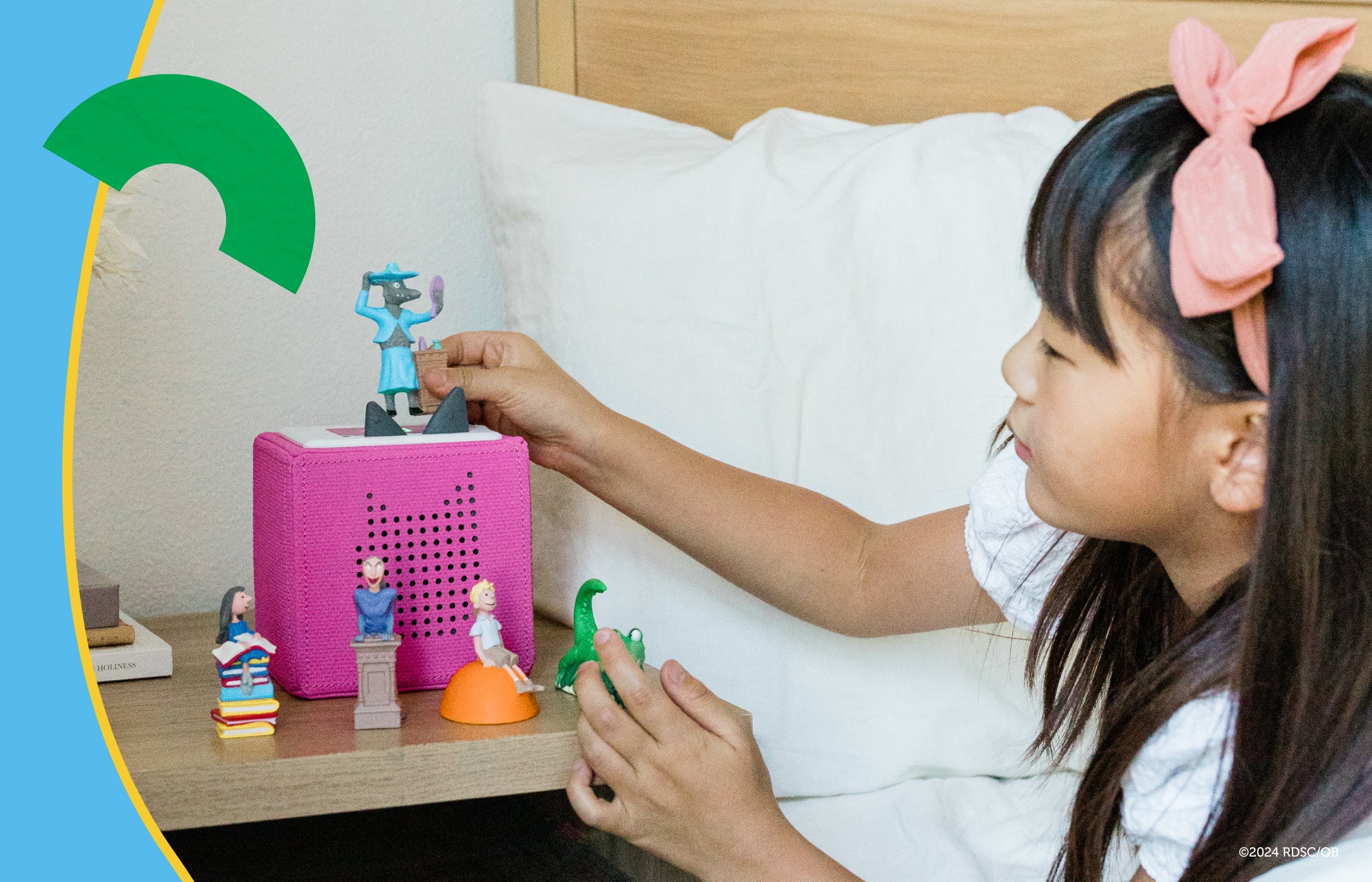 child playing with roald dahl tonies and a pink toniebox