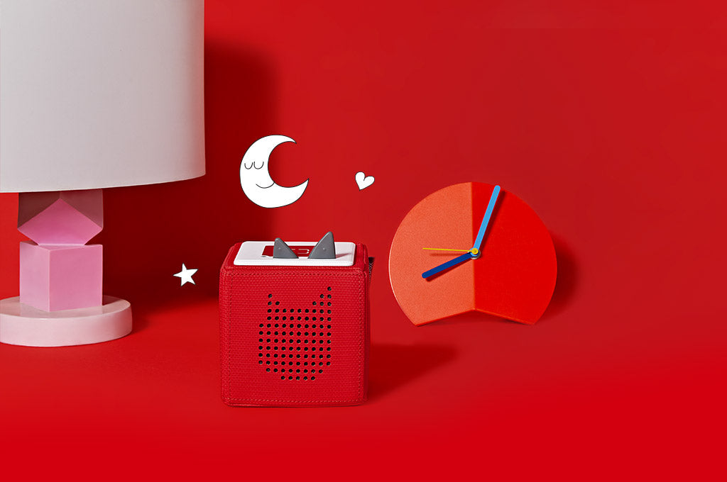 A Red Toniebox with a clock for sleep time