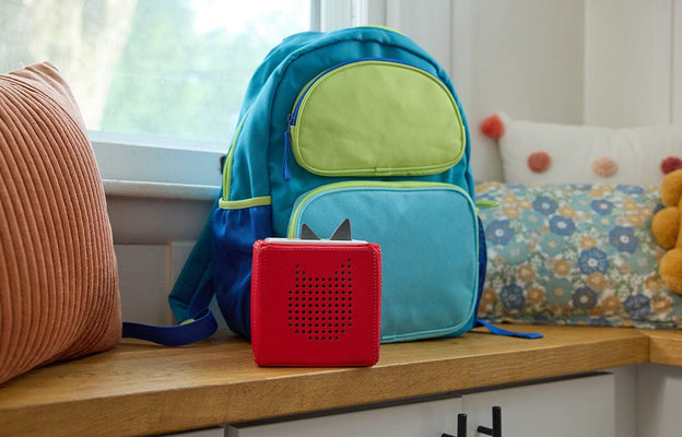 blue and green backpack with a red Toniebox ready for back to school