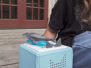 Child Playing With Nat Geo Whale Audio Figurine And Toniebox 2