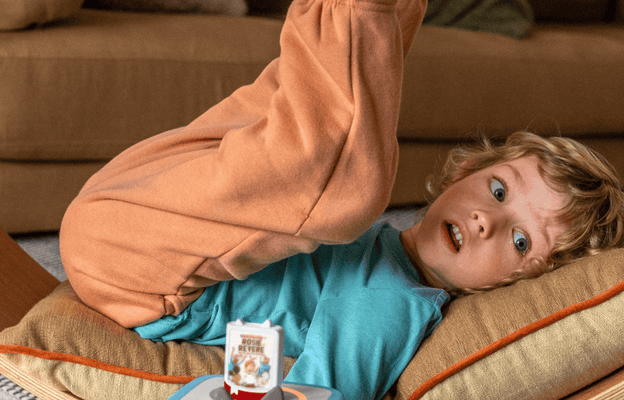 Child listening to Questioneers Audiobook Tonie on a blue Toniebox 2