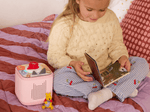 child playing with Toniebox 2 an audio player for kids with Winnie the Pooh Tonie audio figurine and Winnie the Pooh Tiggers Mixup Fixup Tonieplay Game