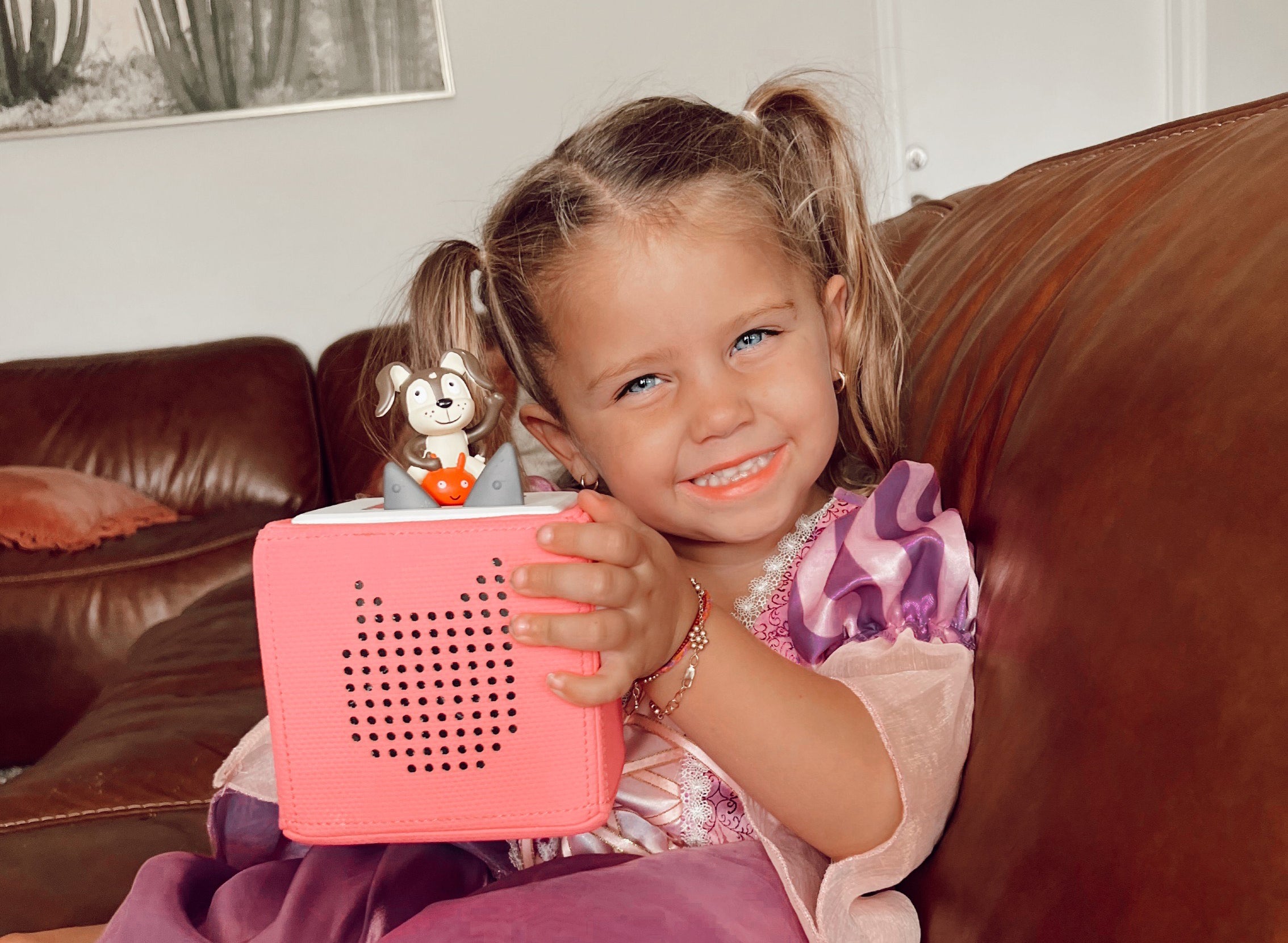 Young girl with pink Toniebox and Playtime Songs Tonie