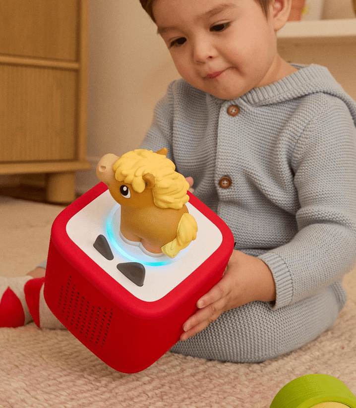 young child listening to the horse my first tonie with a red toniebox 2