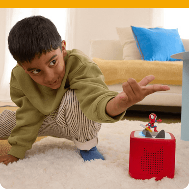 child listening to the spidey tonie on a red toniebox 2